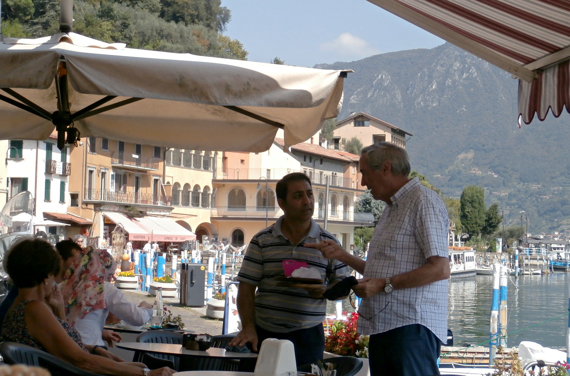 Visitors at lakeside restaurant on Lago d'Iseo